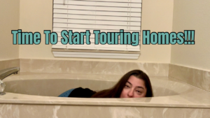 Pam Graham in a garden tub, trying to be funny. The caption reads Time To Start Touring Homes!