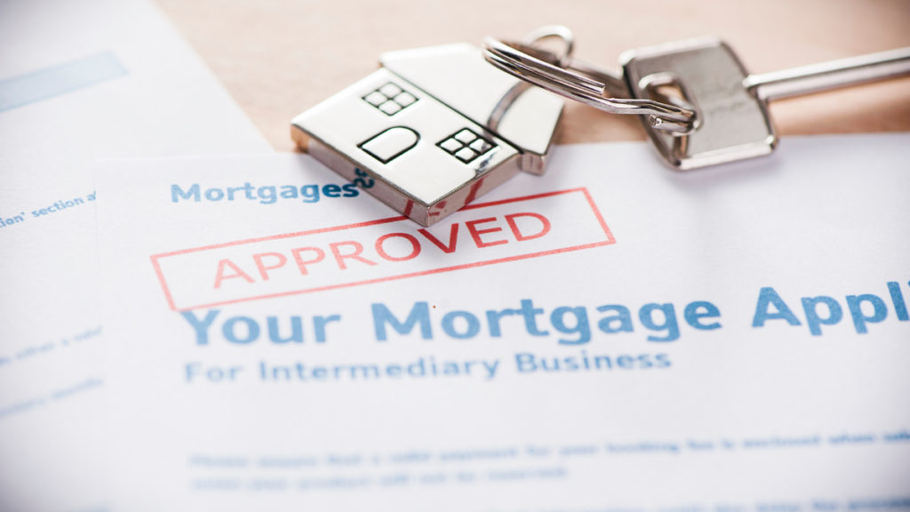 The image shows a house key with documents saying mortgage application approved. 